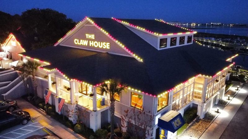 The Claw House restaurant in Murrells Inlet with warm white roofline lights